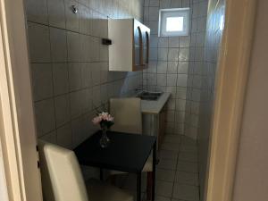 a small bathroom with a table and a sink at Balaton Bloom 24 in Siófok