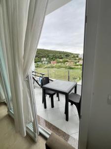 a balcony with a table and a view from a window at Seaside Escape in Draç +1 photo