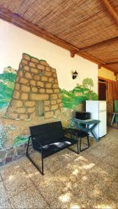 a living room with a wall with a mural at B&B Las Piccas in Santa Maria la Palma +5 photos