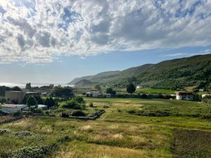 a small town in a field with mountains in the background at Seaside Escape in Draç