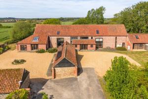 an aerial view of a house with a yard at Peak Hall in Colkirk