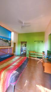a bedroom with a large bed with green walls at B&B Las Piccas in Santa Maria la Palma