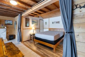 a bedroom with a bed in a room at Lakefront Glamping Cottage- Fishing-Swimming-Boating in Watertown