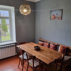 a dining room with a wooden table and a couch at Hooni_guesthouse in Odzun +63 photos