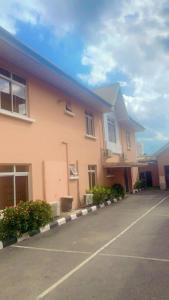 a building with a parking lot in front of it at Trendy Inn limited in Lagos