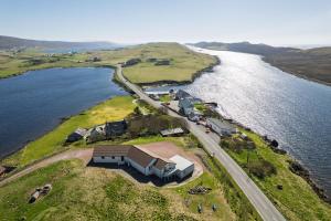 an aerial view of a house on an island in the water at Bellevue House, Shetland Islands in Whiteness