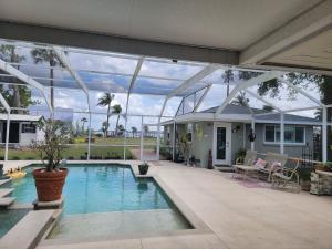 a house with a swimming pool with a large glass ceiling at Manatee River Bungalow in Bradenton