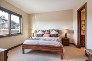 a bedroom with a large bed and a window at White Cloud 16 in Lonsdale