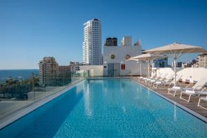 a swimming pool on the roof of a building at Leonardo Plaza Netanya Hotel in Netanya