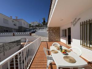 a white table and chairs on a balcony at Alpen1 Finca Simo in Peniscola