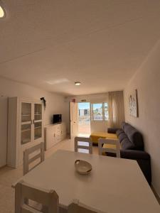 a living room with a table and a couch at Alpen1 Finca Simo in Peniscola