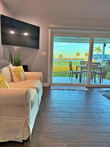 a living room with two beds and a view of the ocean at Manatee River Bungalow in Bradenton
