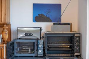 a kitchen with two toaster ovens and a toaster at Ferienwohnung Weitblick im Dahner Felsenland in Bruchweiler-Bärenbach