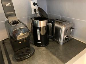 a kitchen counter with a coffee maker and a toaster at La Grenouillère in Miannay