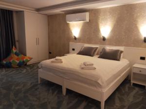 a bedroom with a bed with two towels on it at Bacbery Butik Otel in Çeşme