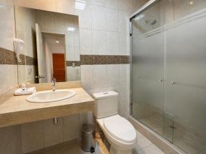 a bathroom with a toilet and a sink and a shower at Hotel Inclan in Lima +34 photos
