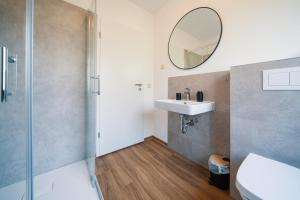 a bathroom with a sink and a mirror at Landhaus Mira in Witzenhausen +36 photos