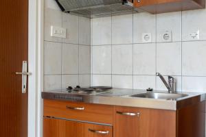 a kitchen with a sink and a counter top at Apartman Lance in Kožino +15 photos