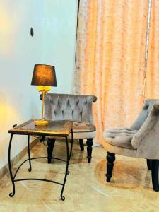 a lamp sitting on a table next to a couch at Prestige A4 in Ouagadougou