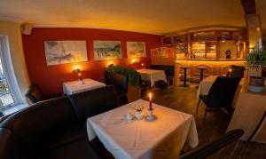 a restaurant with two tables with candles on them at Hotel Im Schwedischen Hof in Binz