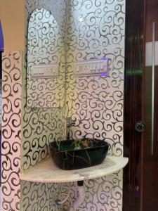 a bathroom with a sink on a shelf with a mirror at Orchid 3BHK 3AC in New Town +51 photos