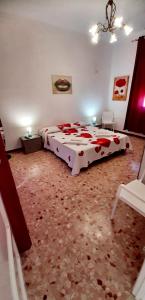 a bedroom with a bed with red roses on it at The house of the islands Sea view in Marausa