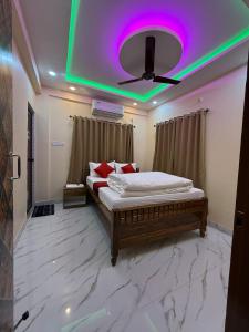 a bedroom with a bed with a purple ceiling at Orchid 3BHK 3AC in New Town