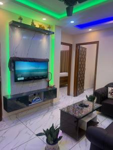 a living room with a flat screen tv on a wall at Orchid 3BHK 3AC in New Town