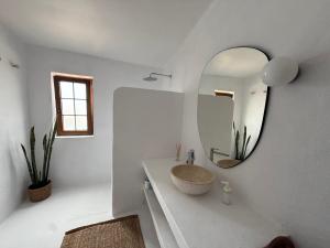 a bathroom with a sink and a mirror on the wall at Villa Ann Lanzarote in Nazaret +19 photos