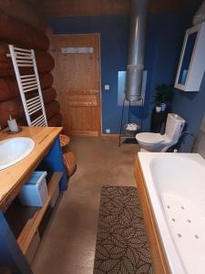 a bathroom with a tub and a sink and a toilet at Lagarta La Fuste in Étival +28 photos