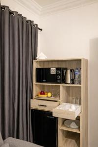 a room with a kitchen with a microwave and a sink at Nile X Hostel - Nile view in Cairo