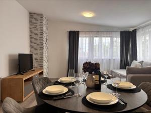 a living room with a table with chairs and a couch at Apartments Šebin in Baška Voda