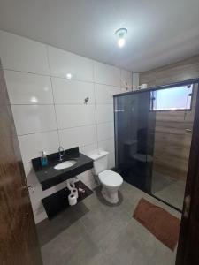 a bathroom with a toilet and a sink and a shower at Hotel Pousa Vale Imperial in Aparecida