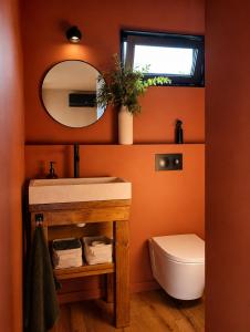 a bathroom with a sink and a toilet and a mirror at Luz Retreat in Luz de Tavira +16 photos