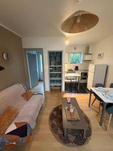 a living room with a couch and a table at DaxLodge T2 Chill in Dax