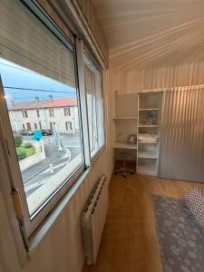 a room with a large window and a radiator at DaxLodge T2 Chill in Dax