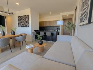 a living room with a couch and a table at Increible departamento en Punto Sur in Los Gavilanes