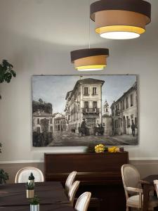 a dining room with a painting on the wall at Hotel Spagna in Arona