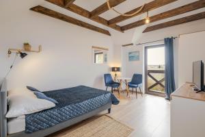 a bedroom with a bed and a table with chairs at Rezydencja nad rzeką in Łeba