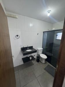 a bathroom with a toilet and a sink and a shower at Hotel Pousa Vale Imperial in Aparecida +25 photos
