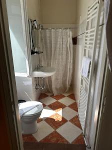 a bathroom with a toilet and a sink at Hotel Spagna in Arona +20 photos