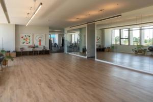 an empty room with a wooden floor and large windows at Increible departamento en Punto Sur in Los Gavilanes +39 photos
