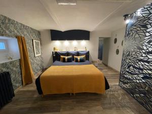a bedroom with a large bed in a room at Entre Nous - La Poste in Saumur