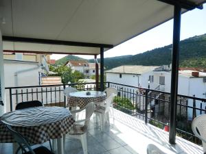 a balcony with tables and chairs and a view at Apartment Jakoubek in Rogoznica