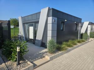 a black and white house with a driveway at Lins B&B Hotel Resort in Marktlustenau