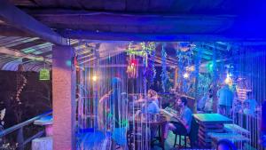 a group of people sitting at a table in a cage at Hostal Tree House in Ella