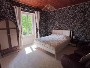 a bedroom with a bed and a window at La-Vialette Chambres d Hôtes in Mont-Roc