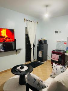a living room with a couch and a tv at Kilifi Studio in Kilifi