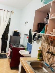 a kitchen with a sink and a stove at Kilifi Studio in Kilifi