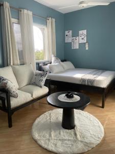 a living room with a bed and a couch and a table at Kilifi Studio in Kilifi